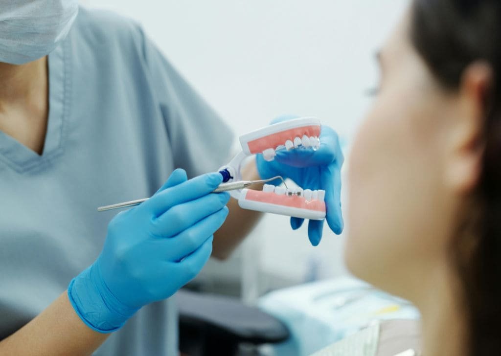 Dentist explaining the procedures and potential braces pain. 